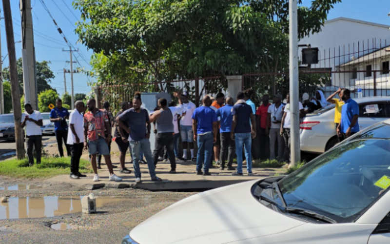 Taxi operators block Spanish Town Road in Kingston in protest of poor road conditions and raw sewage on the roadway