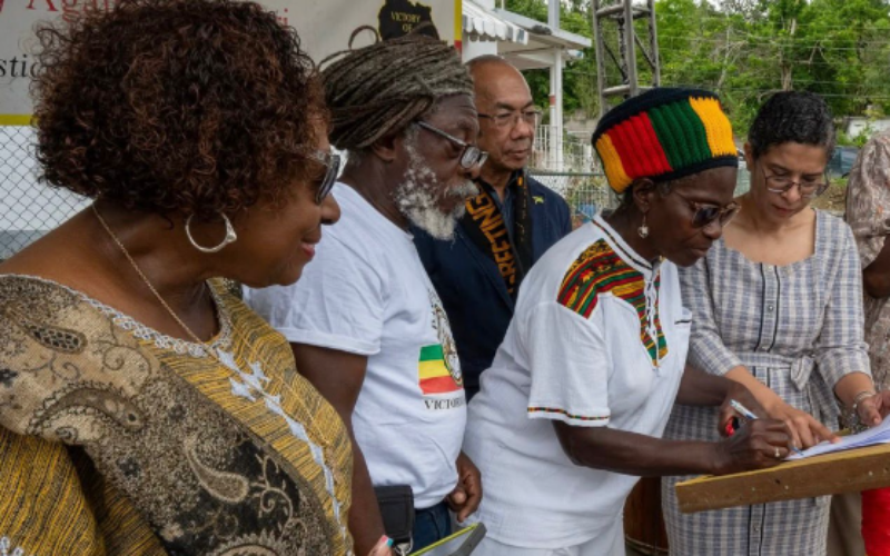 Land titles for Albion Heights handed over to the Rastafari Coral Gardens Benevolent Society
